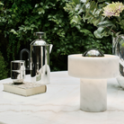 The Stone Portable Light by Tom Dixon in Silver on a table.