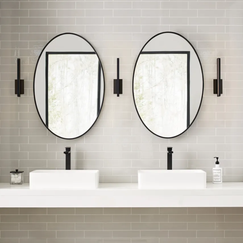 The Banda Vertical Wall Sconce from Visual Comfort & Co. in a jack and jill bathroom.