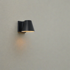 The Bowman Outdoor Wall Sconce from Visual Comfort and Co in an outdoor living area.