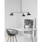 The black and brass Charlton Large Triple Arm Chandelier from Visual Comfort & Co in a dining room.