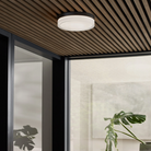 The Cirque Outdoor Flush Mount from Visual Comfort and Co in a lounge area.