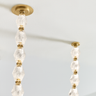 The Collier 108 Chandelier from Visual Comfort and Co in natural brass close-up of ceiling attachment.
