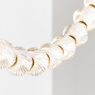 The Collier 108 Chandelier from Visual Comfort and Co in natural Brass in a kitchen, shown in detail.