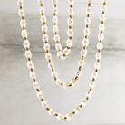 Close-up image of the Collier 108 Chandelier from Visual Comfort & Co in natural brass.