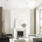 The Collier 84 Chandelier from Visual Comfort and Co in natural brass in a living room.