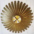 The Hampton Medium Chandelier from Visual Comfort and Co in antique gold from the bottom in a home.