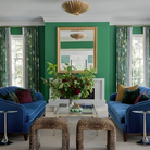 The Hampton Medium Chandelier from Visual Comfort and Co in antique gold in a living space.