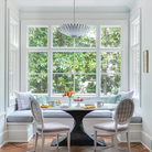 The Hampton Medium Chandelier from Visual Comfort and Co in plaster white in a dining room.