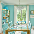 The Hampton Medium Chandelier from Visual Comfort and Co in plaster white in a dining space.