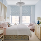 The Hampton Medium Chandelier from Visual Comfort and Co in plaster white in a primary bedroom.