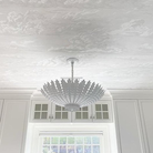 The Hampton Medium Chandelier from Visual Comfort and Co in plaster white in a restaurant.