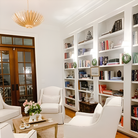 The Hampton Mini Chandelier from Visual Comfort and Co in antique gold in a living room.