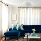 The Hampton Mini Chandelier from Visual Comfort and Co in plaster white in a family room.