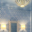 The Hampton Mini Chandelier from Visual Comfort and Co in plaster white in a primary bedroom.