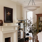 The Mollino Large Tiered Chandelier from Visual Comfort and Co in bronze in a dining room.