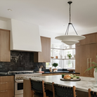 The Mollino Large Tiered Chandelier from Visual Comfort and Co in bronze in a kitchen.
