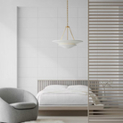 The Mollino Large Tiered Chandelier from Visual Comfort and Co in hand-rubbed antique brass in a bedroom.