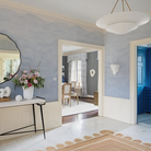 The Mollino Large Tiered Chandelier from Visual Comfort and Co in hand-rubbed antique brass in an entryway.