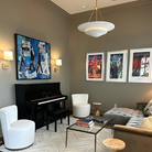 The Mollino Large Tiered Chandelier from Visual Comfort and Co in hand-rubbed antique brass in a living room