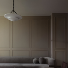 The Mollino Medium Tiered Chandelier from Visual Comfort and Co in bronze in a living room.