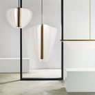 The Nyra Linear Suspension from Visual Comfort and Co in a living room.