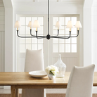 The Piaf Grande Chandelier from Visual Comfort & Co. in aged iron and ebonized oak in a family area.