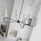 The Piaf Grande Chandelier from Visual Comfort & Co. in aged iron and ebonized oak in a living space.