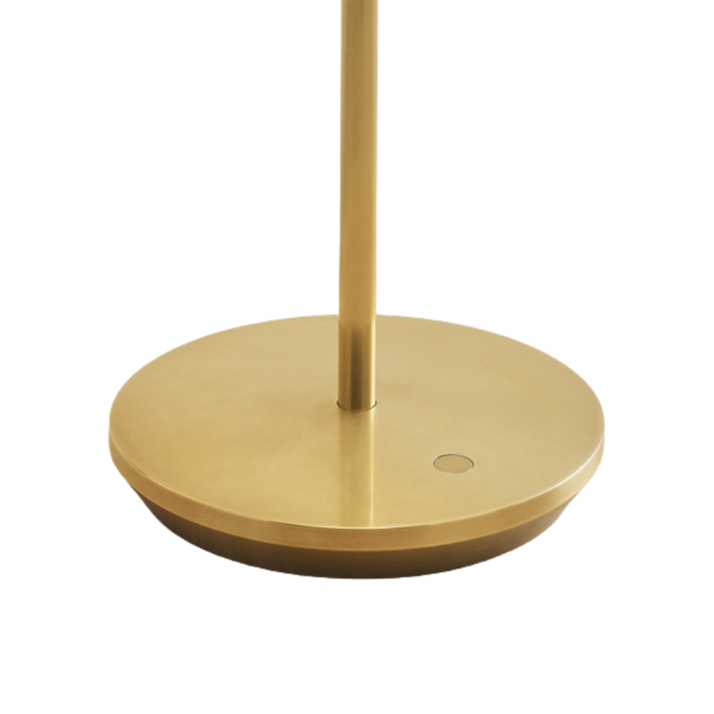 The Nevis Accent Rechargeable Table Lamp gold from Visual Comfort Co with a close-up of the base.
