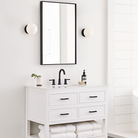 The Lune 1-Light Bath Sconce from Visual Comfort & Co in Aged Iron in a bathroom.