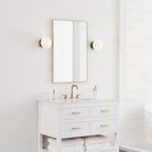 The Lune 1-Light Bath Sconce from Visual Comfort & Co in Burnished Brass in a bathroom.