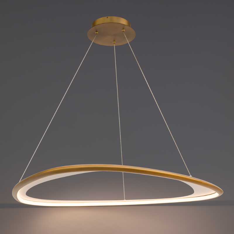 The 42-inch Oyster Color Select LED Pendant in Aged Brass by WAC Lighting turned on.