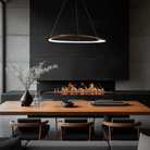 The 42-inch Oyster Color Select LED Pendant in Aged Brass by WAC Lighting over a dining table in a modern home.