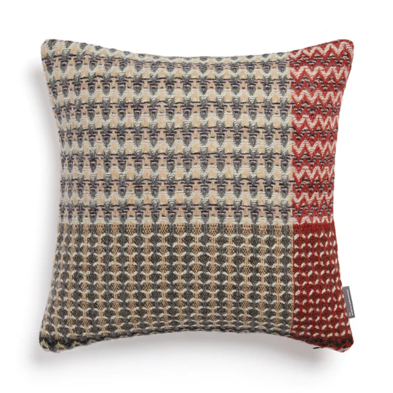 The Ansel Cushion by Wallace & Sewell is made of 100% shetland wool. Grey throw pillow with rust accents.