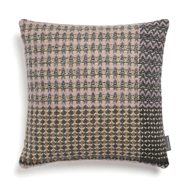 The Ansel Cushion by Wallace & Sewell is made of 100% shetland wool. Lavender and grey accents.