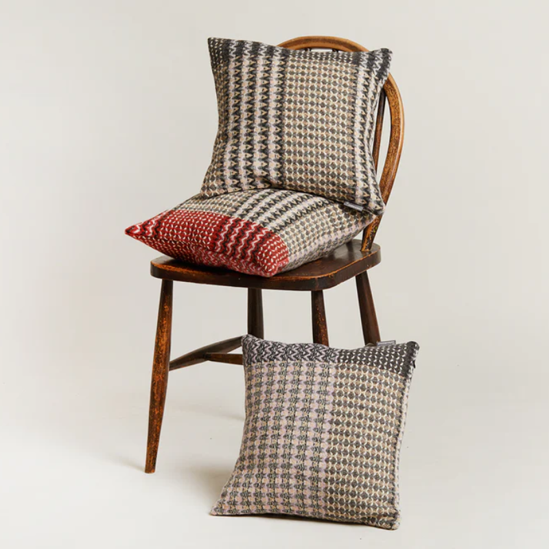 The Ansel Cushion by Wallace & Sewell is made of 100% shetland wool on a chair.