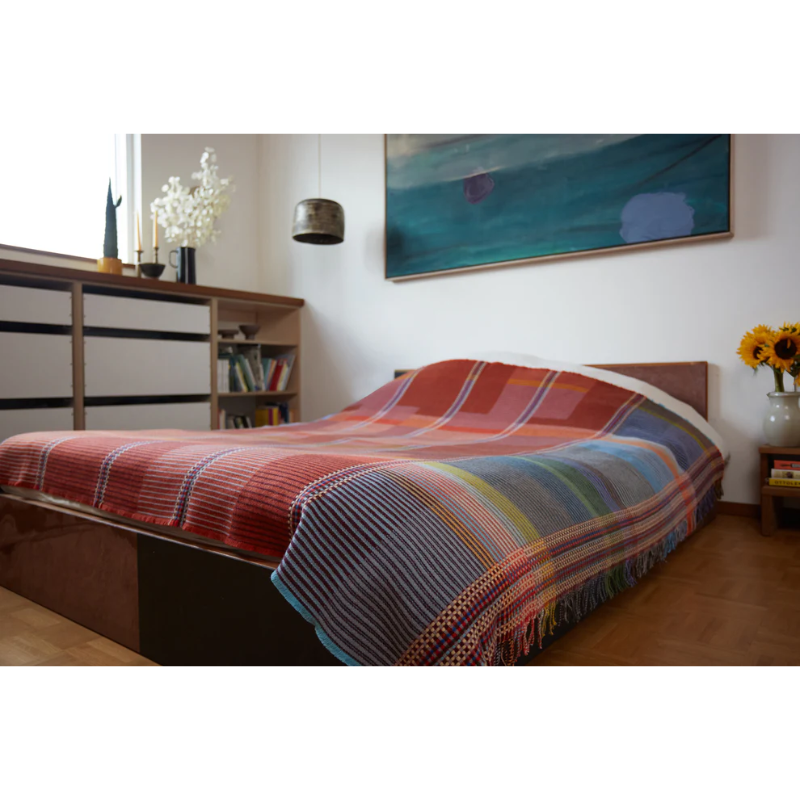 Wallace & Sewell’s Beatrix Pinstripe Throw on a bed.