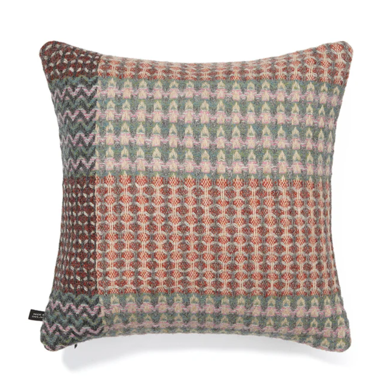 The Bryce Cushion by Wallace & Sewell. Made of 100% Shetland Wool. Cushion with muted sage green, pink, and red tones.