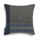 Textured pillow with blue and beige pattern.