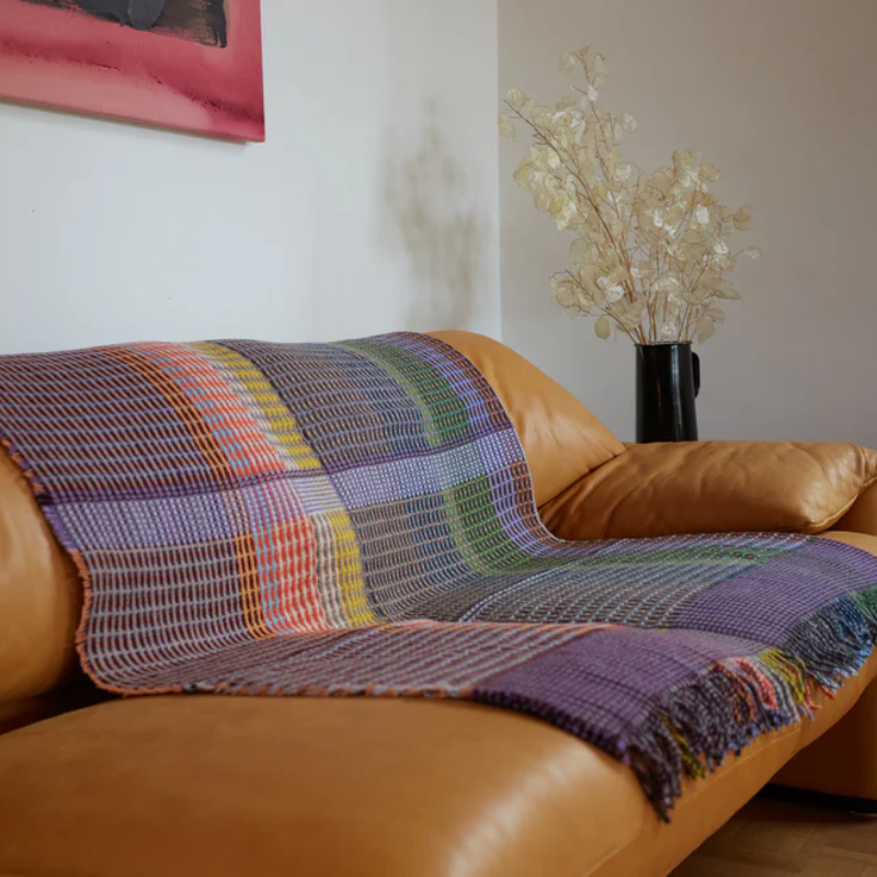 The Jankel Basket Throw ALT by Wallace & Sewell on a sofa.