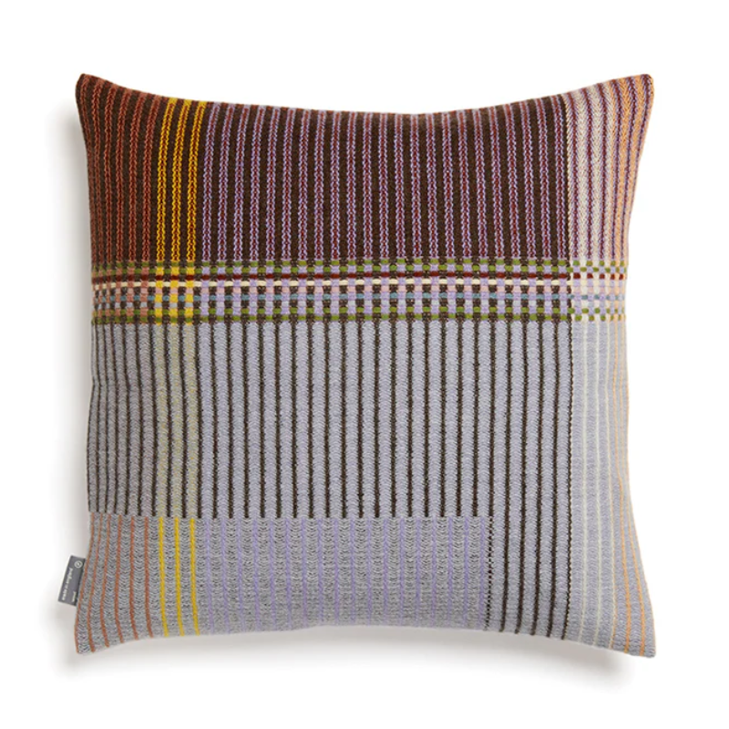 The Joan Cushion by Wallace & Sewell has light grey, burnt sienna, mossy green and highlights of pale yellow and blush sprinkled throughout.