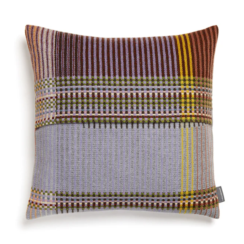 The Joan Cushion by Wallace & Sewell has light grey, burnt sienna, mossy green and highlights of pale yellow and blush sprinkled throughout.