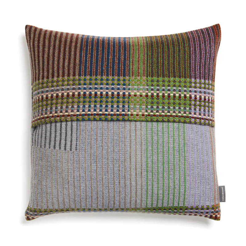The Joan Cushion by Wallace & Sewell has light grey, burnt sienna, mossy green and highlights of pale yellow and blush sprinkled throughout.