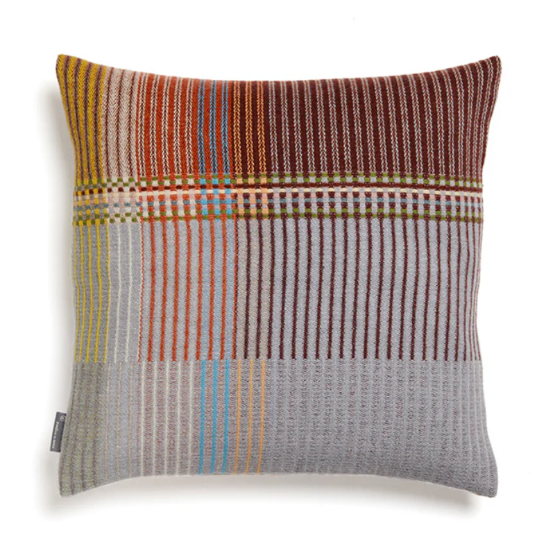 The Joan Cushion by Wallace & Sewell has light grey, burnt sienna, mossy green and highlights of pale yellow and blush sprinkled throughout.