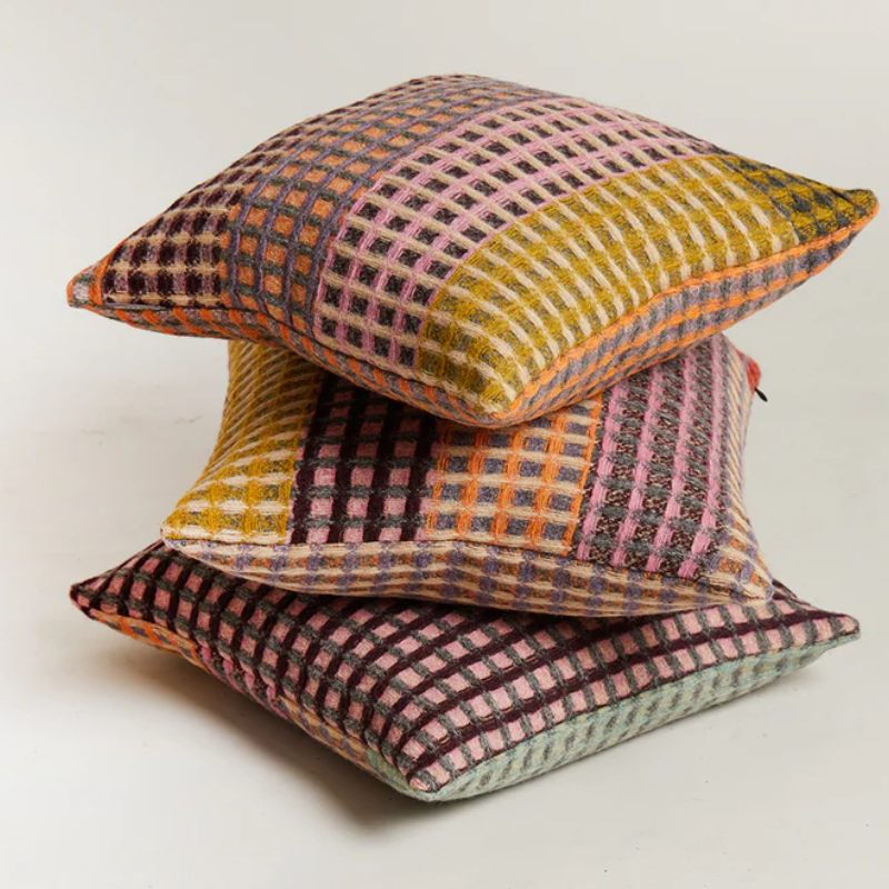 The Kew Cushion by Wallace and Sewell is made of natural shetland wool. All three colorways of stacked.