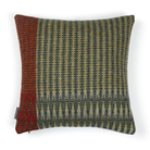 The Lismore Cushion by Wallace & Sewell features a blend of woven green, red, and chartreuse natural fibers.