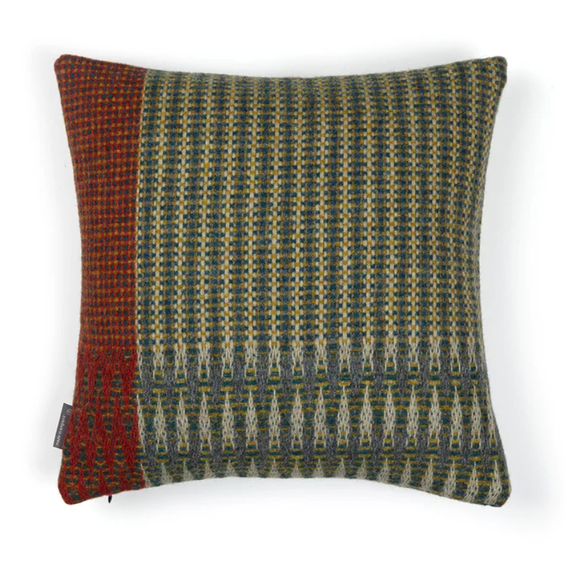 The Lismore Cushion by Wallace & Sewell features a blend of woven green, red, and chartreuse natural fibers.