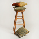 The Lismore Cushion by Wallace & Sewell on a stool.