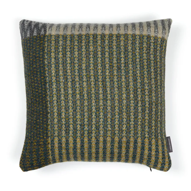 The Lismore Cushion by Wallace & Sewell features a blend vibrant green tones of shetland wool natural fibers.