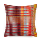 Wallace & Sewell’s Lovelace Basket Weave Cushion has colorful tones of red, orange,  purple, yellow, and light blue.