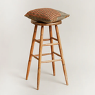The Yosemite Cushion by Wallace & Sewell on a stool.